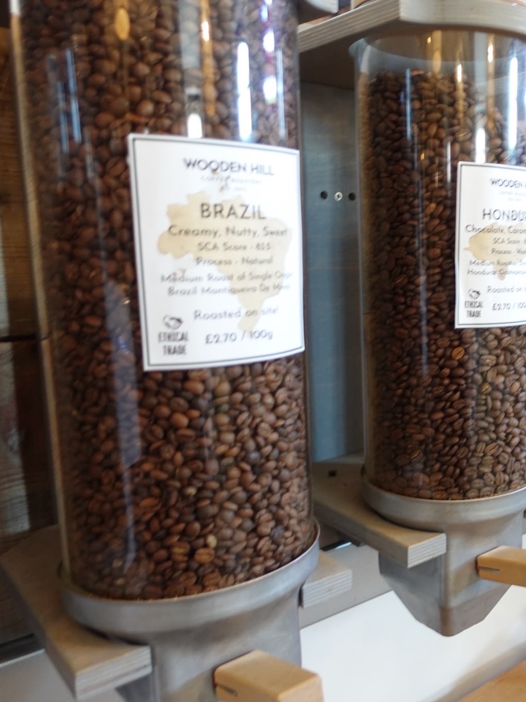 Wooden Hill Coffee Company's bean dispensers, each labelled with its single origin and roast